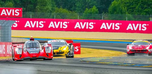 An Avis trackside banner is seen Le Mans 2023