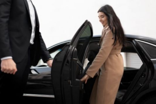 Avis branded luxury vehicle with chauffeur, exemplifying tailored travel experiences.