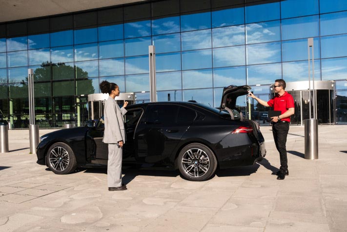 An Avis First customer greets an Avis concierge