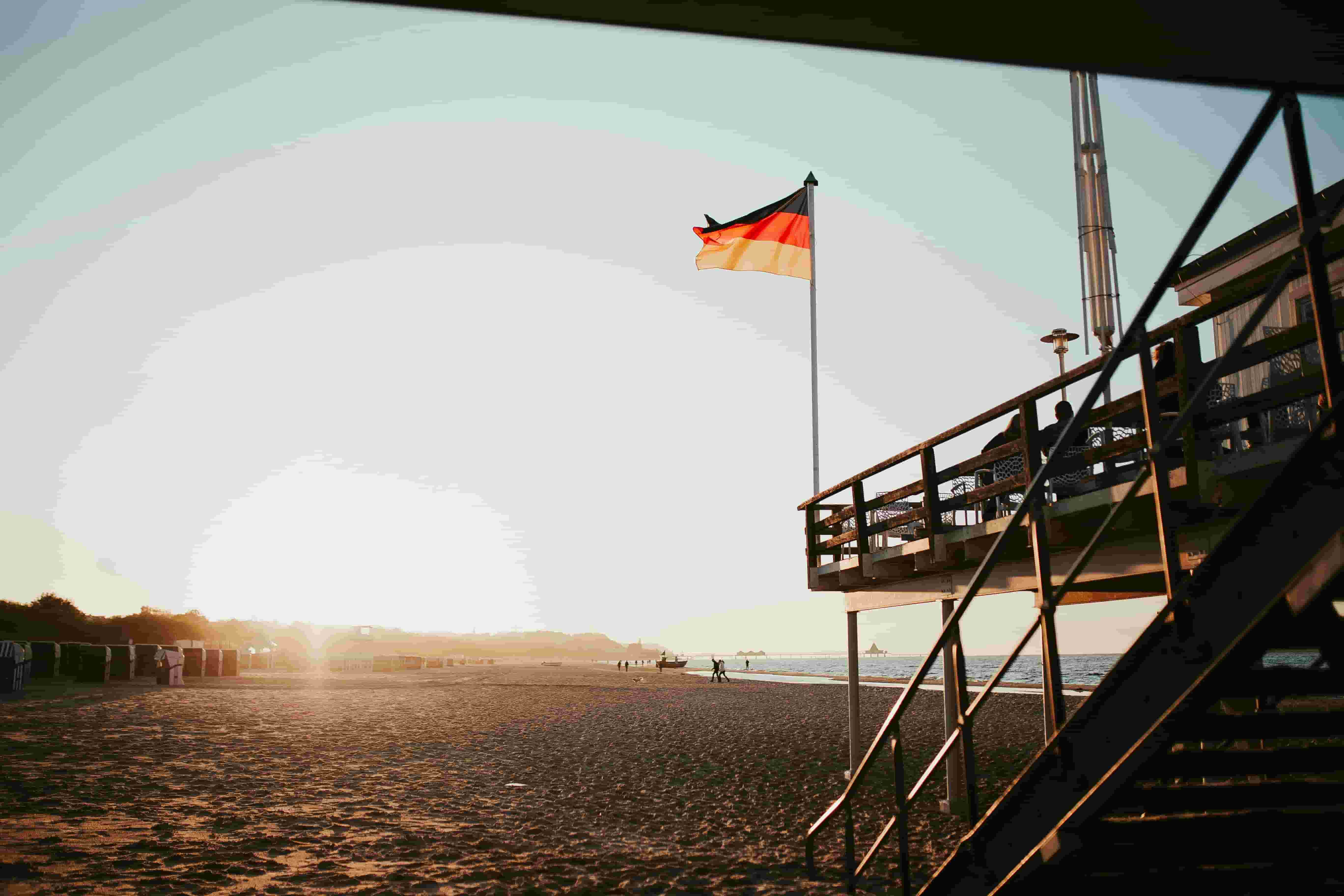 Beach and pier near Berlin with Germany flag flying