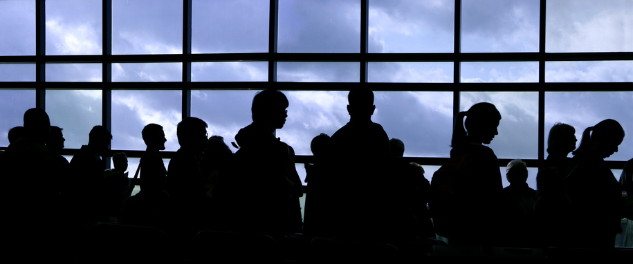 Passagerer i en lang kø i lufthavnen