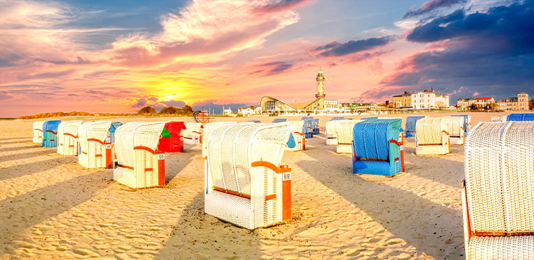 Strand-Warnemünde-Rostock beach in Germany showing golden sand and bright beach huts
