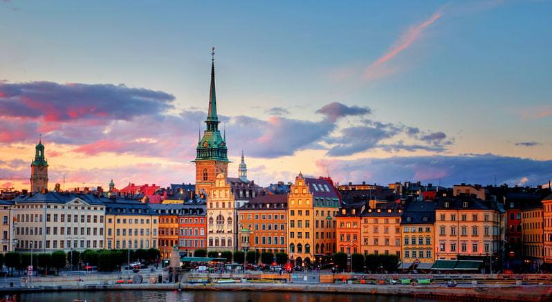 Stockholm's old town, Gamla Stan with ochre and painted houses by the waterside at dusk