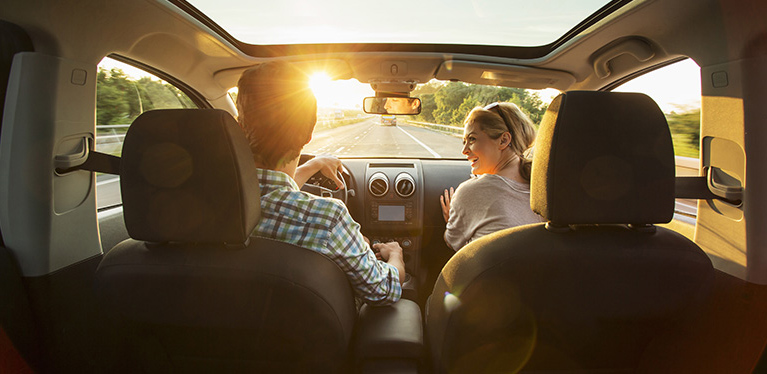 A young driver in an Avis rental car