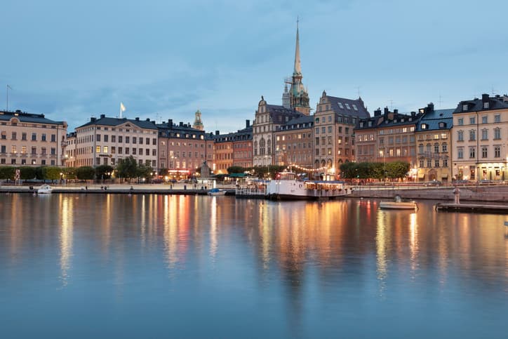 Early evening light on Gamla Stan, the old town in Stockholm, lights on water and typical Scandinavian arch
