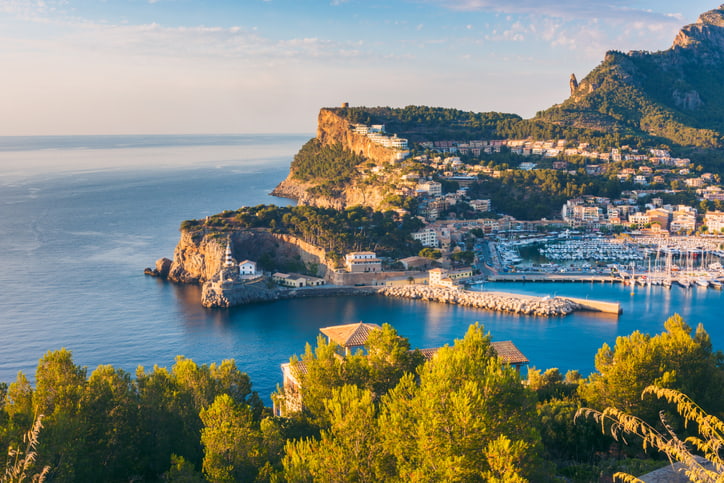 The cliff side village of Port de Soller, blue sea and sky