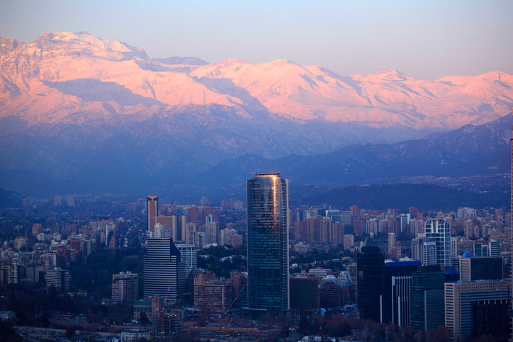 Skyline of Santiago in Chile at dawn with Andes Mountain range behind