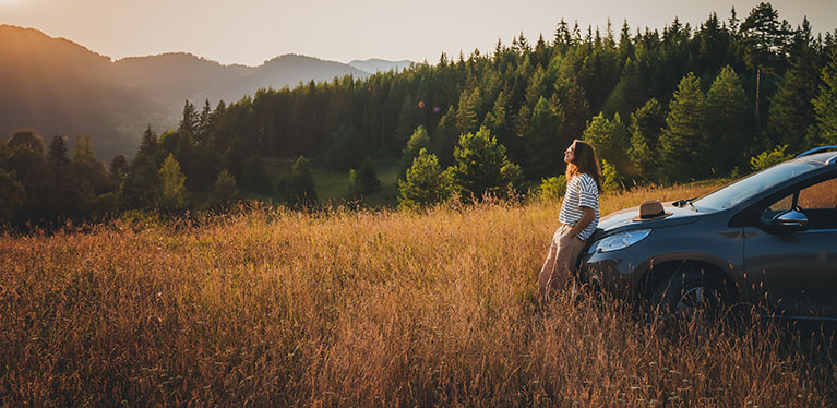 Image showing a lady relaxing on her rental car bonnet